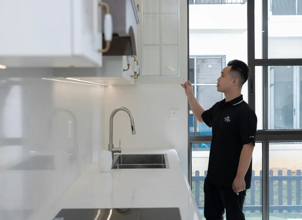 Emergency plumber inspecting kitchen plumbing in a modern Slough home